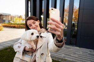 Smiling women taking selfie with her pet